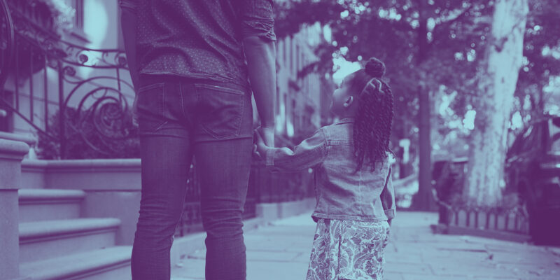 A treated image of a father and daughter holding hands and walking down the street.